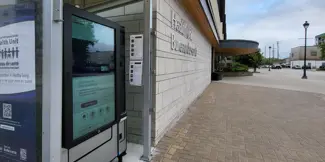 Image of a touch-screen, health and wellness supply vending machine outdoors