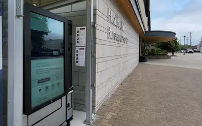 Image of a touch-screen, health and wellness supply vending machine outdoors